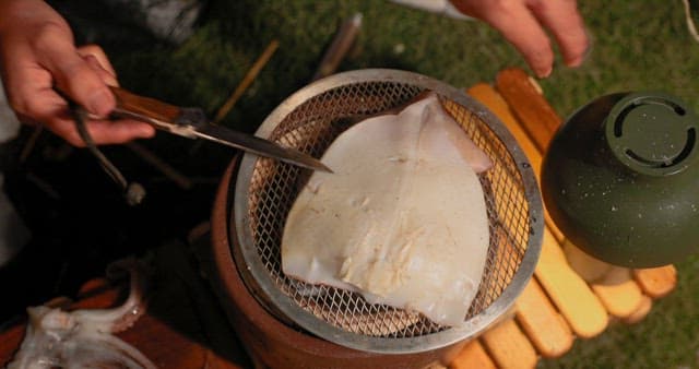 Preparing Squid on a Grill Outdoors