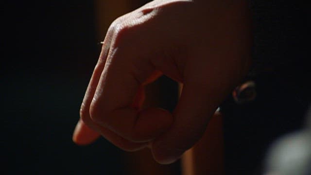 Relaxed Gesture of Tapping Fingers on Black Cloth