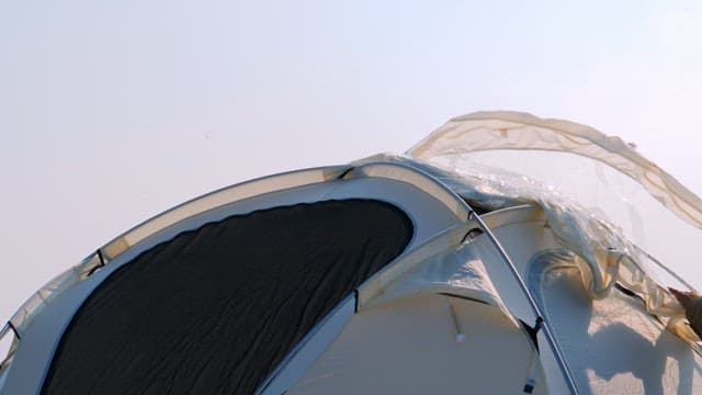 Tent being set up under clear sky