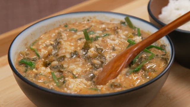 Spoonful of rice with a savory chueotang of chives and dried radish greens