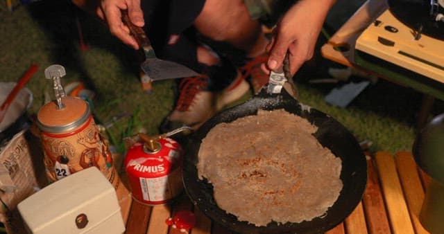Preparing Vegetable Pancakes Outdoors at Night during Camping