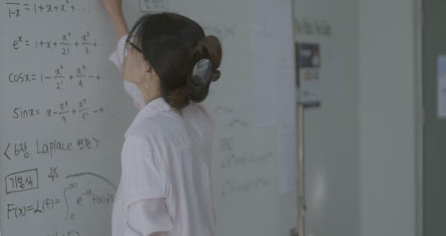 Teacher erasing writing on the whiteboard