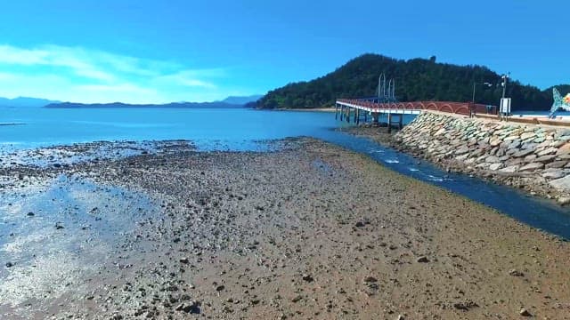 Aerial View of Pier Over Serene Coastal Waters