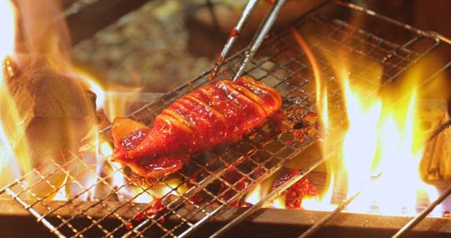 Sizzling squid being cooked on a grill