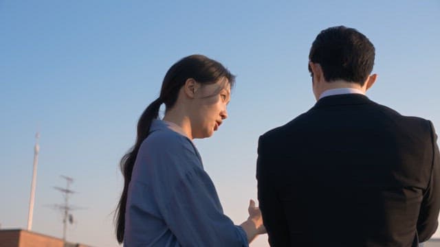 Two people having a conversation outdoors