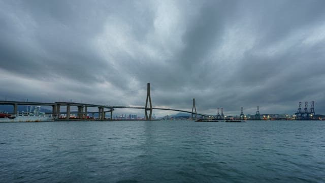 Change in the sky with gloomy clouds over the Busan Port Bridge and the sea
