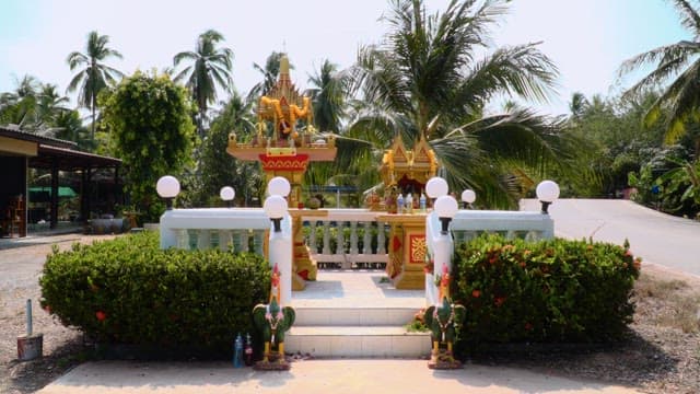 Vibrant altar adorned with flowers and statues on a sunny day