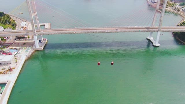 Cable cars crossing a bridge over water