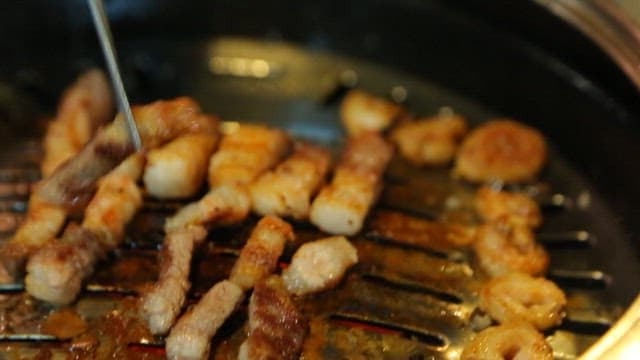Pork belly dipped in bean flour served on perilla leaf