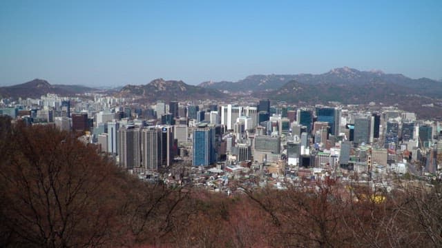 Cityscape view with buildings from a mountain in the morning