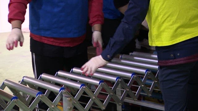 People Moving Boxes of Packed CSAT Question Papers