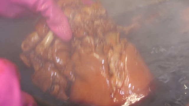 Pig's feet cooked in a large cauldron