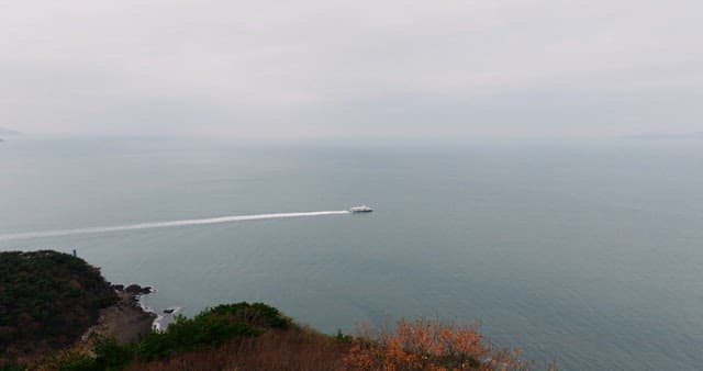 Boat sailing on serene sea near coastline