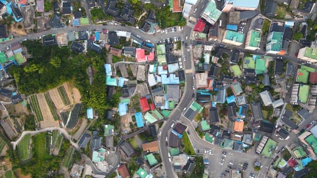 View of a city with green fields