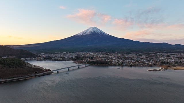 Mount Fuji with a cityscape at sunset