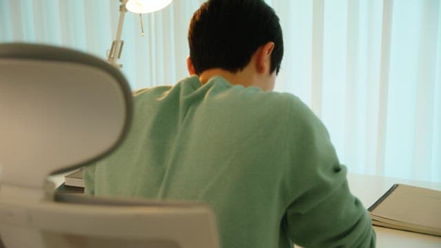 Man sitting at a desk in a calmly lit room