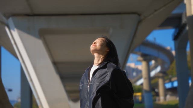 Woman stretching in a sunny park
