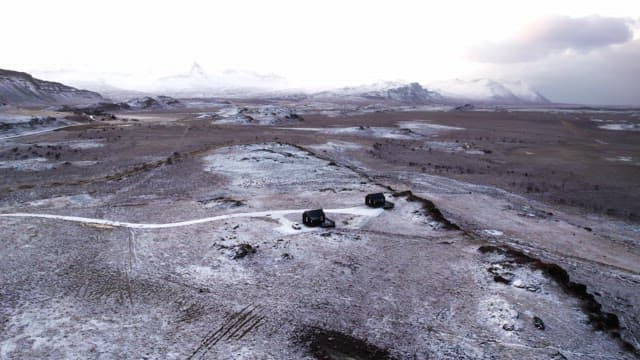 Snow-covered landscape with distant mountains