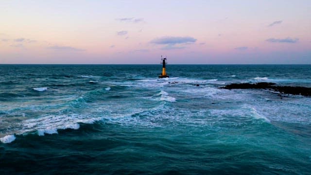 Serene Coastal Seascape at Dusk with Lone Lighthouse