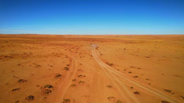 Vehicles Traversing a Desert Landscape