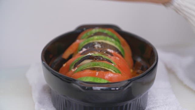 Two plates of fresh ratatouille with zucchini and tomatoes