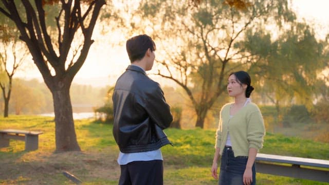 Couple arguing in a sunny park