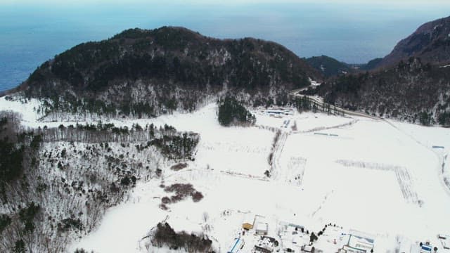 Blue Sky and Sea Beyond the Snow-Capped Mountains