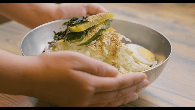 Jjolmyeon Topped with Sesame Seeds and Cabbage