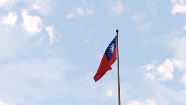 Taiwan National Flag Waving Against Blue Sky
