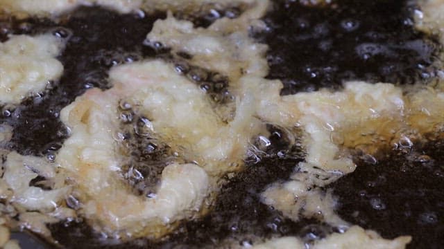 Deep frying food in hot oil in the kitchen