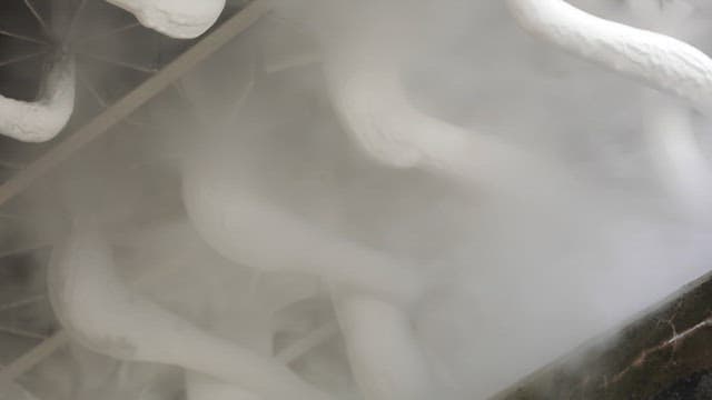 Industrial pipes emitting dense vapor indoors