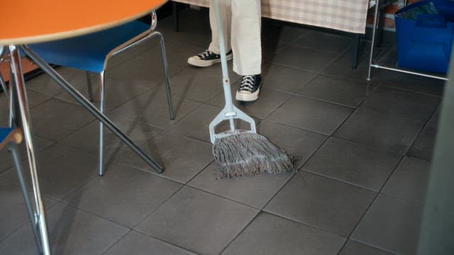Person mopping the floor indoors