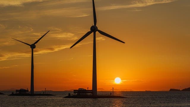Red Sunset over the Sea with Wind Turbines