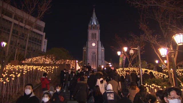 People Visiting the Illuminated Cathedral at Night
