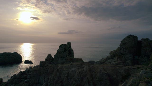 Serene Seaside Cliffs Illuminated by the Twilight Sun