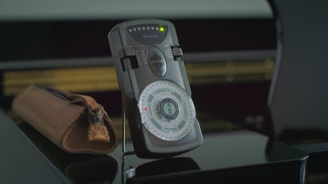 Metronome ticking over a piano background