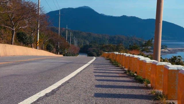 Serene Coastal Road with Mountain View