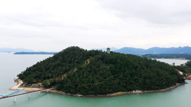 View of lush green island surrounded by calm sea