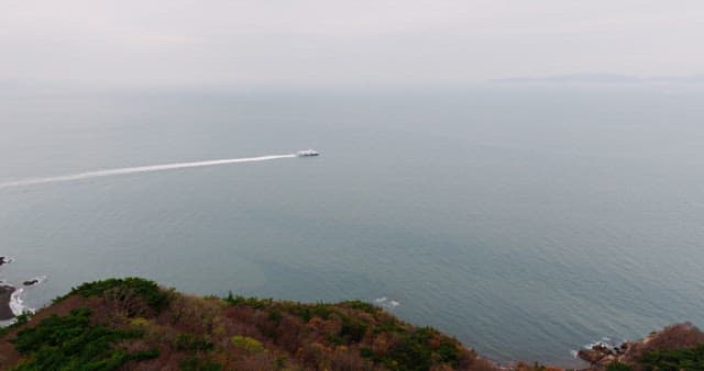 Boat sailing on serene sea near coastline