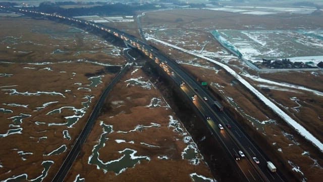 Highway through snowy fields