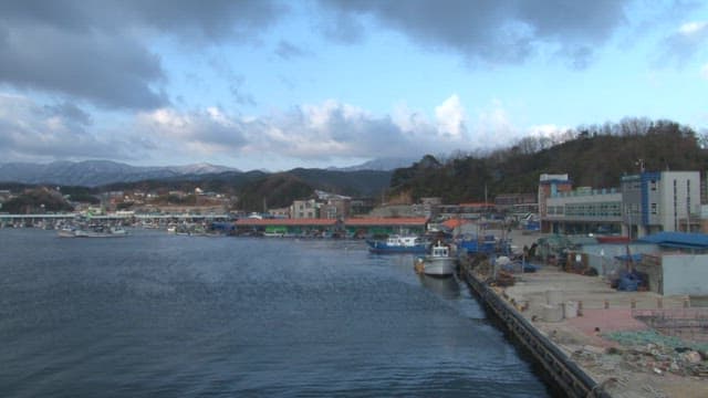 Coastal Village with Boats and Rugged Shoreline