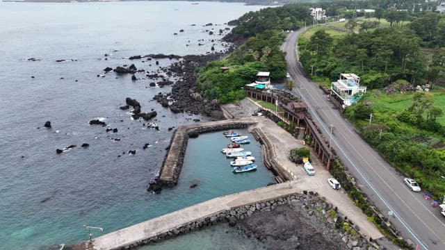 Coastal road and small harbor with boats