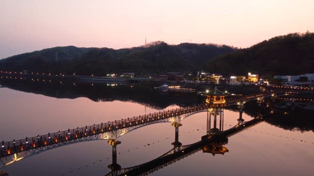 Scenic bridge over a calm river at sunset
