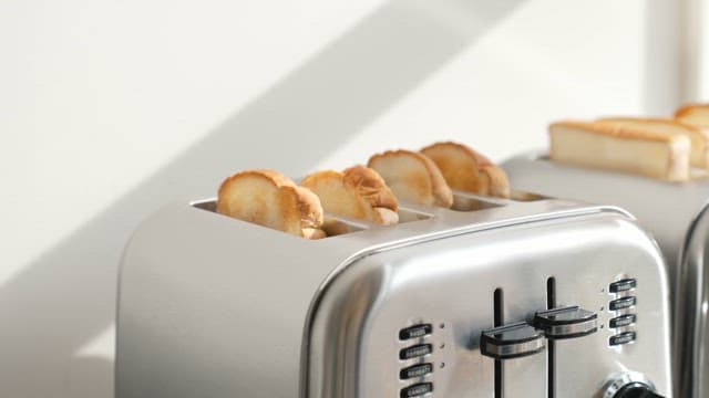 Toasting bread in a shiny toaster