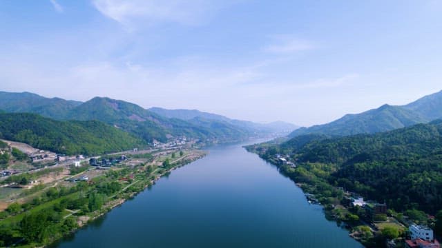 Village with Beautiful Mountains and a Calm River