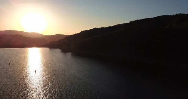 Sunset over a tranquil lake and mountains