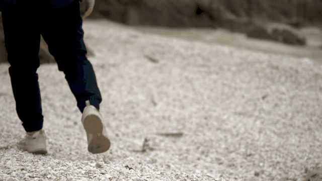 Walking over a shell-covered shoreline