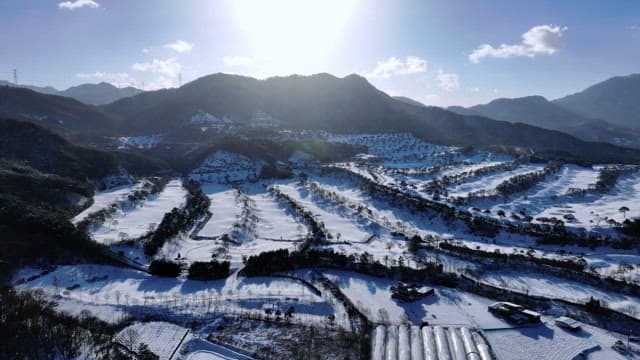 Snow-covered valley bathed in sunlight