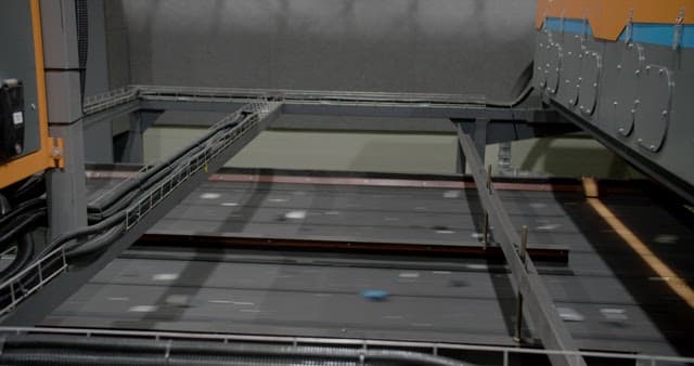 Solar Panels Carried by Conveyor Belt at a Factory