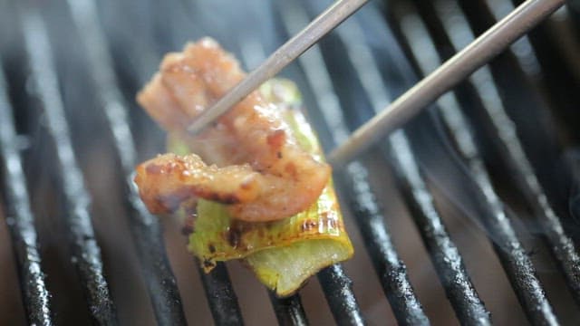 Grilled pork parts served with grilled leeks